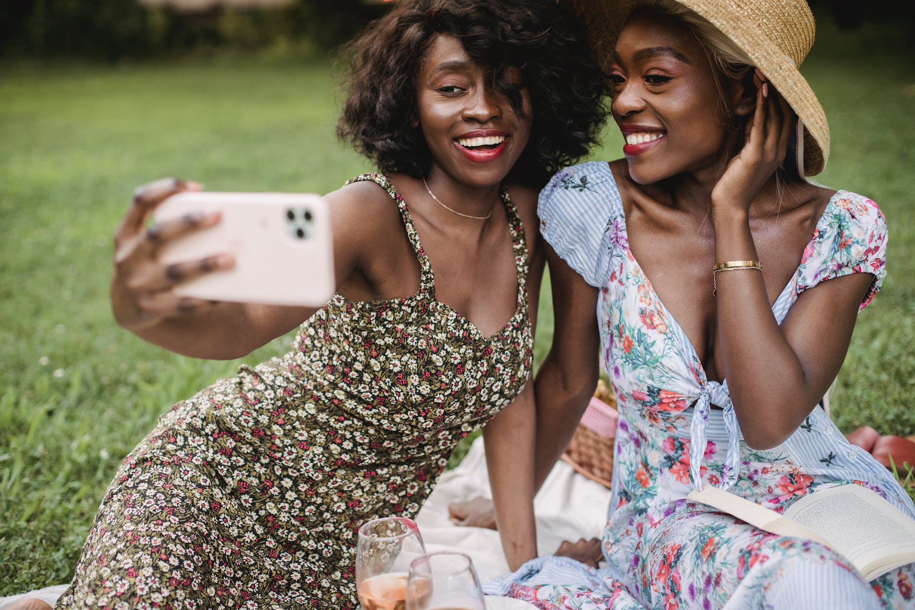women in floral dress taking selfie